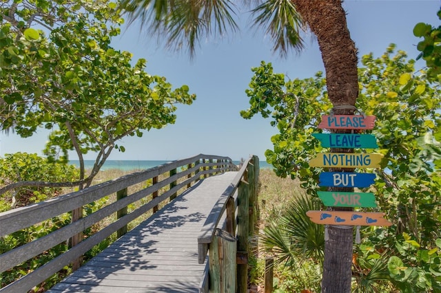 view of property's community featuring a beach view and a water view