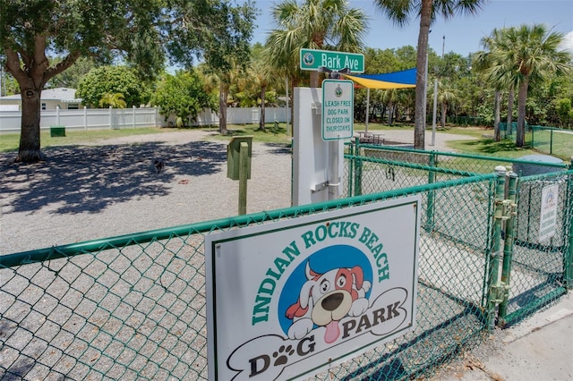 view of property's community featuring fence and a gate