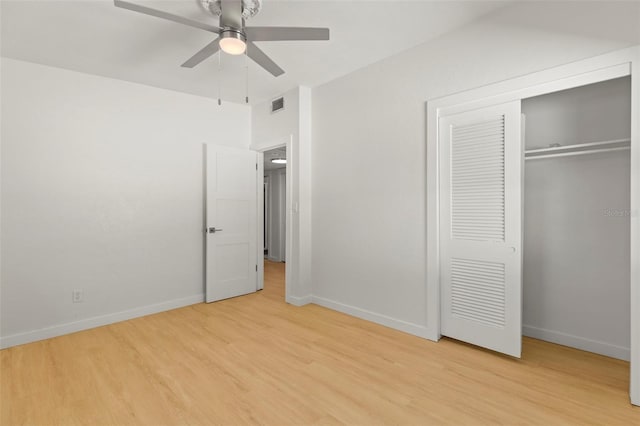 unfurnished bedroom with a closet, visible vents, baseboards, and light wood-style floors