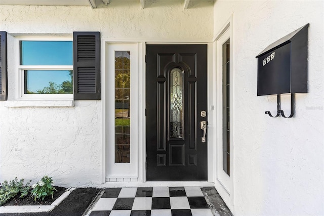 property entrance featuring stucco siding