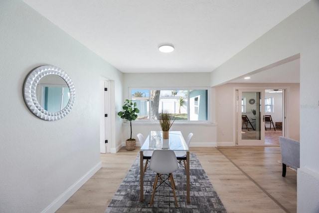 dining room featuring baseboards and light wood-style flooring
