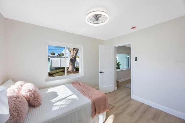 bedroom with baseboards and light wood-style floors