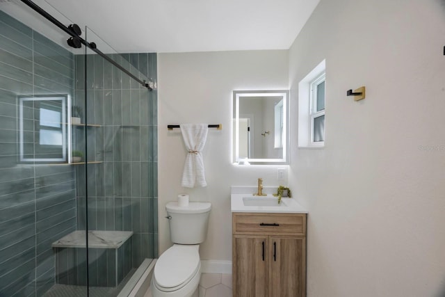 full bathroom featuring tile patterned flooring, toilet, vanity, baseboards, and a stall shower