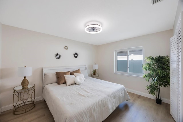 bedroom with light wood-style flooring and baseboards