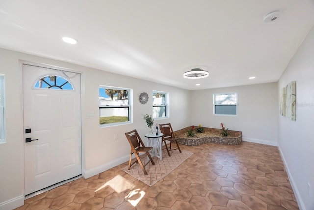 foyer featuring baseboards and recessed lighting