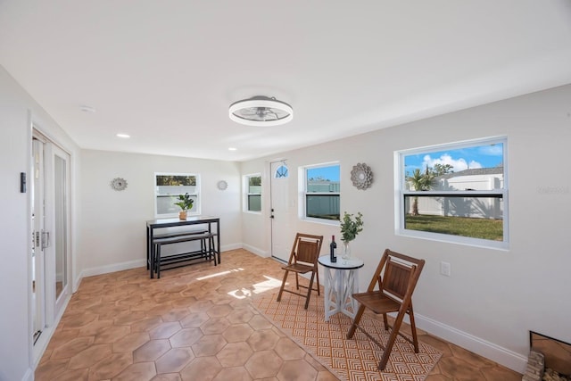 living area featuring recessed lighting and baseboards