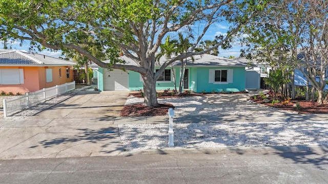 single story home with driveway and fence