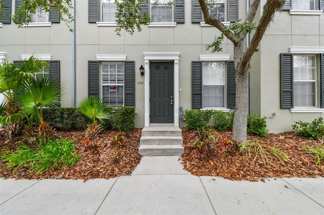 doorway to property with stucco siding