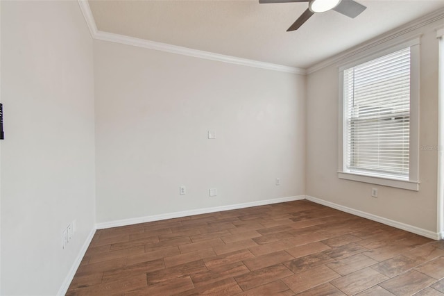 unfurnished room featuring baseboards, ceiling fan, ornamental molding, and wood finished floors