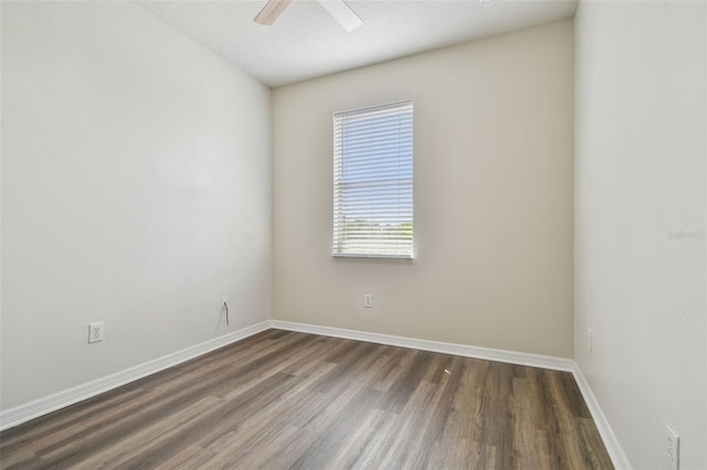 empty room with baseboards, ceiling fan, and wood finished floors