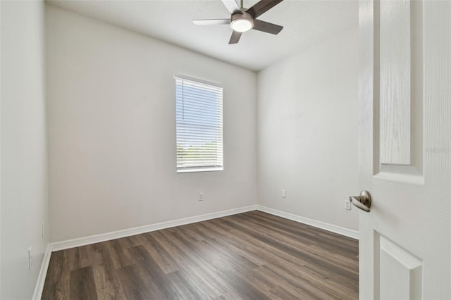 empty room featuring ceiling fan, dark wood-style floors, and baseboards