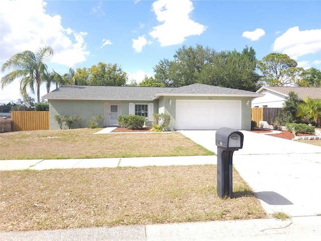 single story home with fence, a front lawn, brick siding, a garage, and driveway