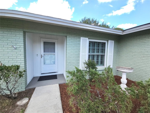 entrance to property with brick siding