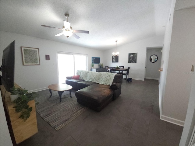 living room featuring baseboards, lofted ceiling, and ceiling fan with notable chandelier
