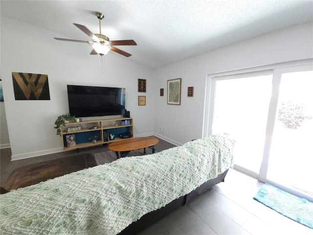 living room featuring baseboards, ceiling fan, vaulted ceiling, and a healthy amount of sunlight