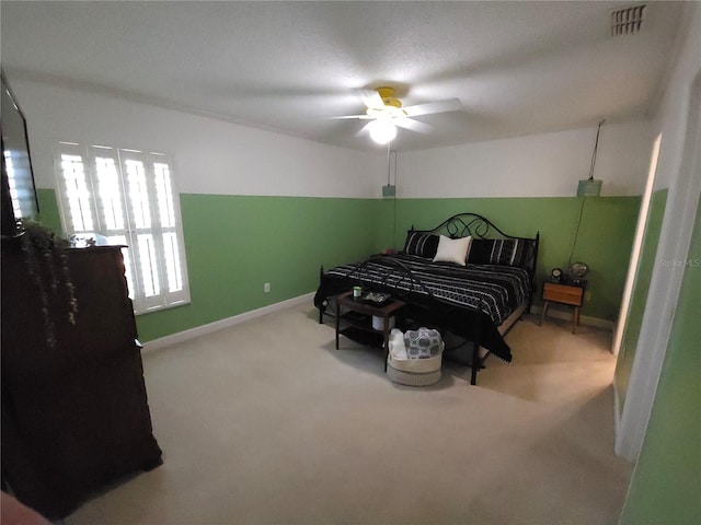 bedroom with a ceiling fan, baseboards, visible vents, and carpet