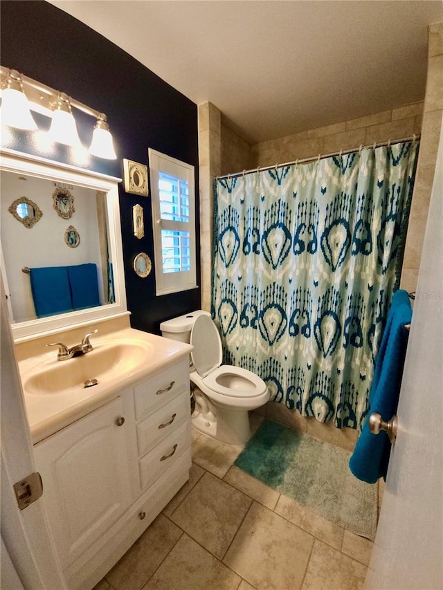 bathroom featuring vanity, tile patterned floors, toilet, and curtained shower