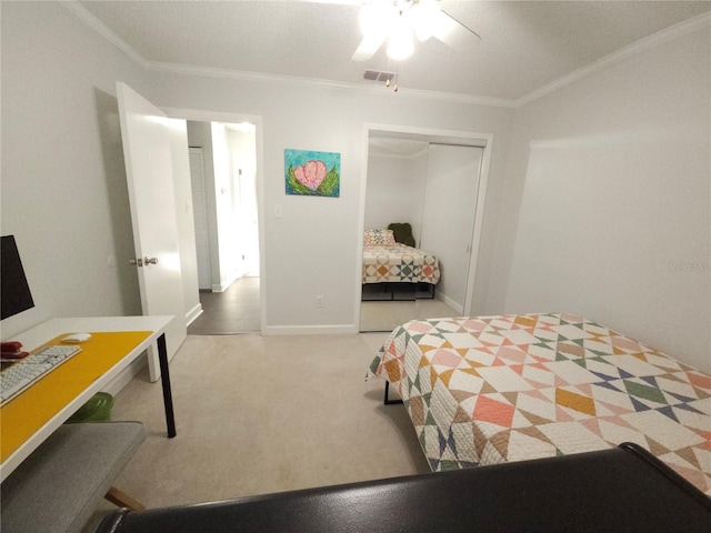 carpeted bedroom with baseboards, visible vents, ornamental molding, and a closet