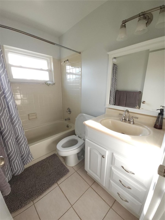 bathroom featuring vanity, tile patterned flooring, shower / bath combo with shower curtain, and toilet