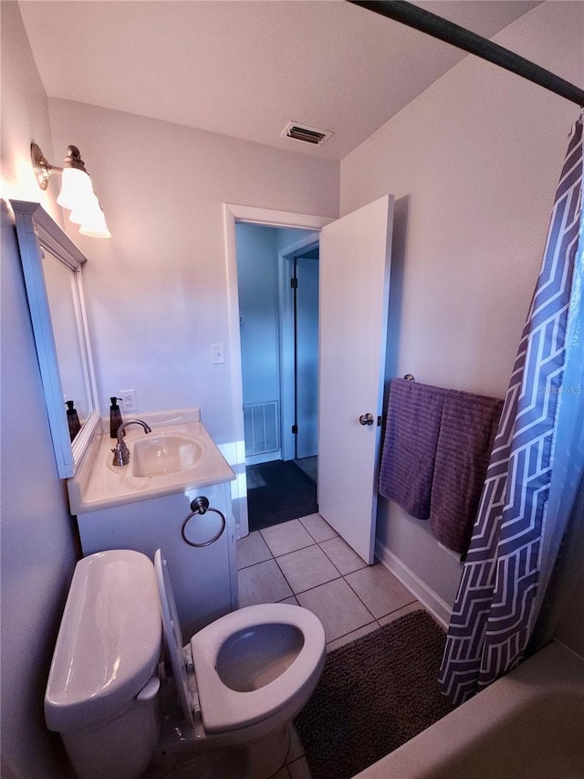 bathroom with toilet, visible vents, tile patterned flooring, and vanity