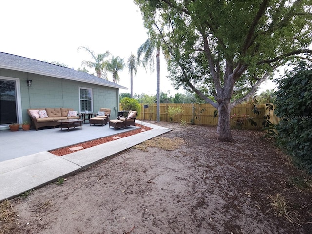 view of yard featuring a patio, a fenced backyard, and an outdoor hangout area