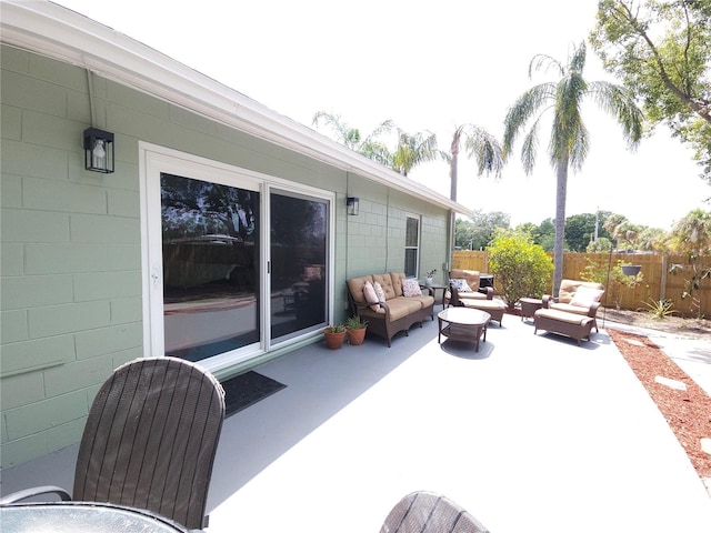 view of patio with fence and outdoor lounge area