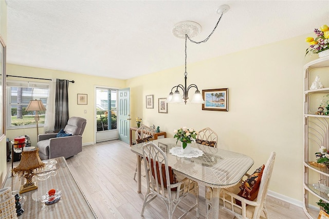 5216 81st St N Unit 2, Saint Petersburg, FL 33709 - dining space featuring a chandelier and light wood-type flooring