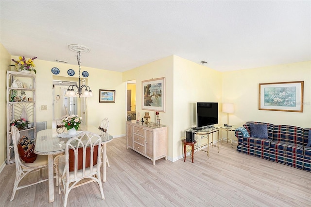 5216 81st St N Unit 2, Saint Petersburg, FL 33709 - dining room featuring light wood-style flooring and a chandelier