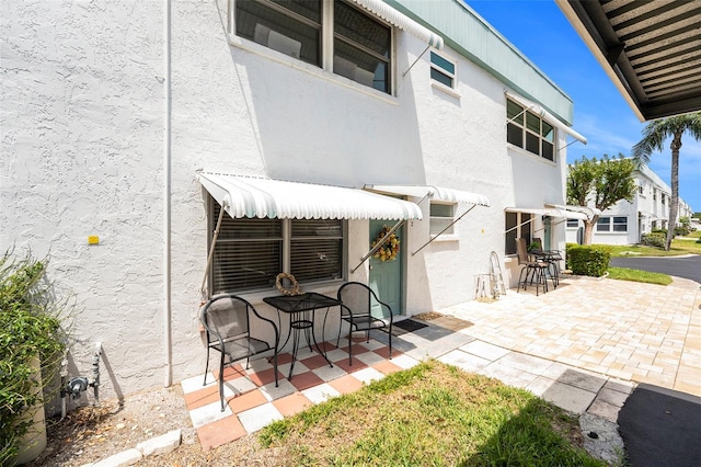5216 81st St N Unit 2, Saint Petersburg, FL 33709 - back of property featuring stucco siding and a patio