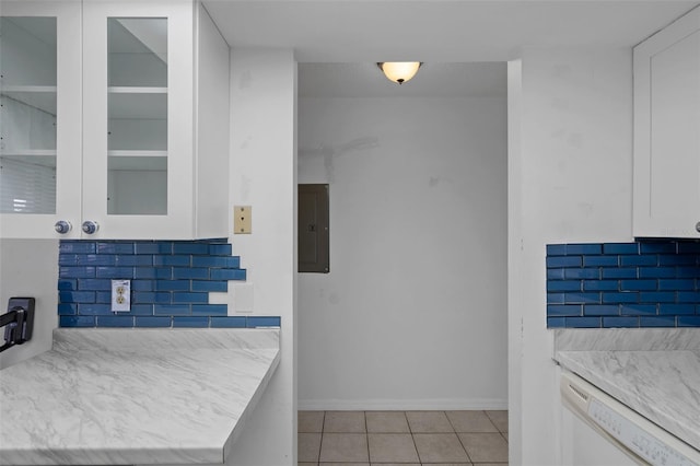 kitchen featuring electric panel, white cabinetry, dishwasher, glass insert cabinets, and light tile patterned flooring