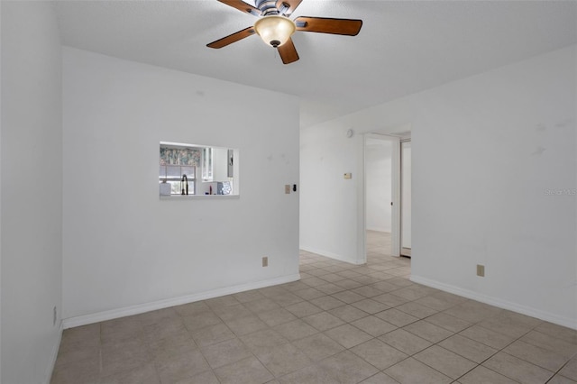 unfurnished room with a ceiling fan and light tile patterned flooring