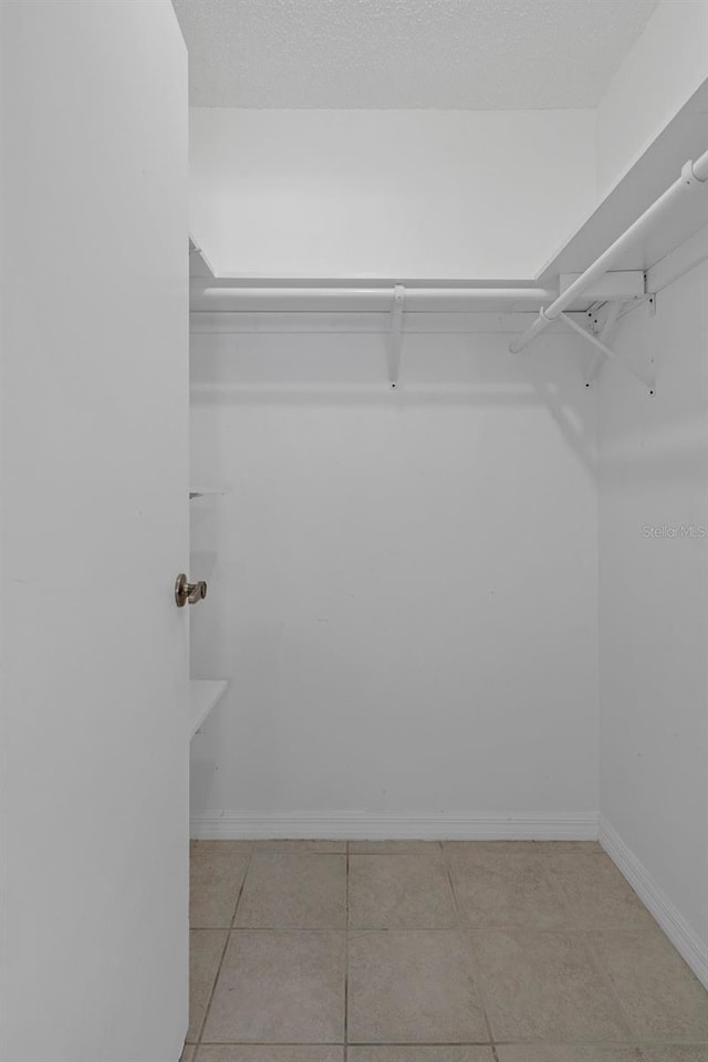 spacious closet featuring light tile patterned flooring