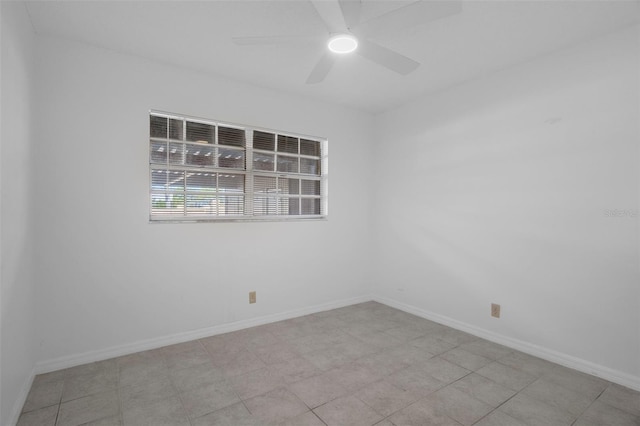empty room featuring baseboards and a ceiling fan