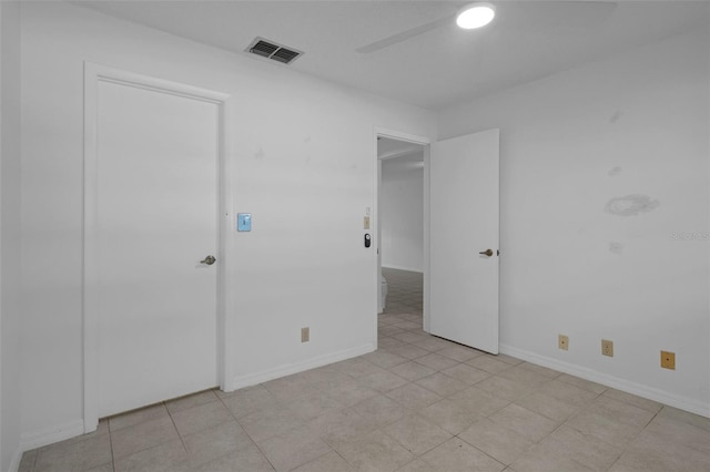 unfurnished room with a ceiling fan, baseboards, and visible vents