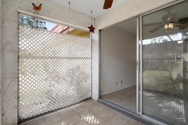 exterior details with a ceiling fan and stucco siding