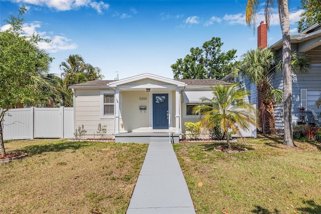 3300 Jackson St N, Saint Petersburg, FL 33704 - bungalow-style house with fence and a front lawn