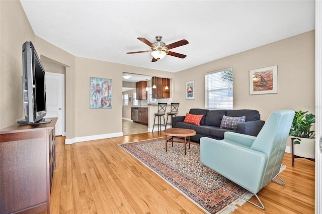 3300 Jackson St N, Saint Petersburg, FL 33704 - living room featuring baseboards, a ceiling fan, and light wood finished floors