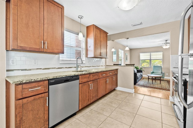 3300 Jackson St N, Saint Petersburg, FL 33704 - kitchen featuring brown cabinets, tasteful backsplash, a sink, ceiling fan, and dishwasher