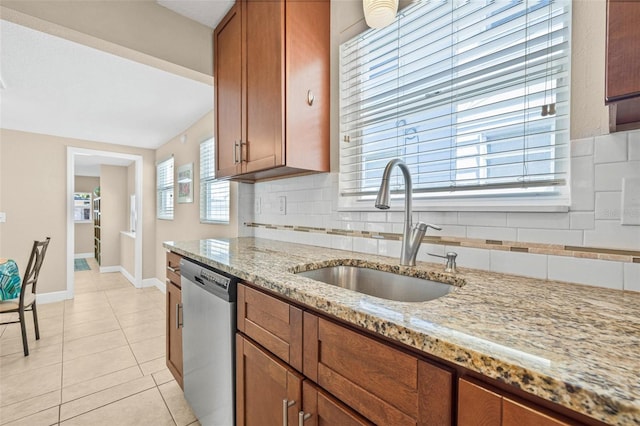 3300 Jackson St N, Saint Petersburg, FL 33704 - kitchen with stainless steel dishwasher, brown cabinets, decorative backsplash, and a sink
