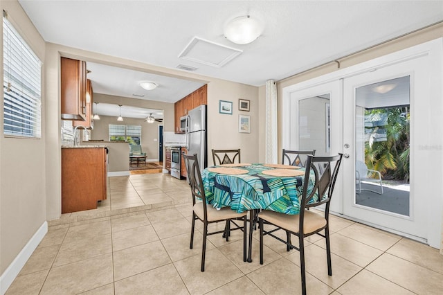 3300 Jackson St N, Saint Petersburg, FL 33704 - dining area with attic access, light tile patterned floors, french doors, and baseboards