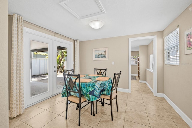 3300 Jackson St N, Saint Petersburg, FL 33704 - dining area with light tile patterned flooring, french doors, plenty of natural light, and baseboards
