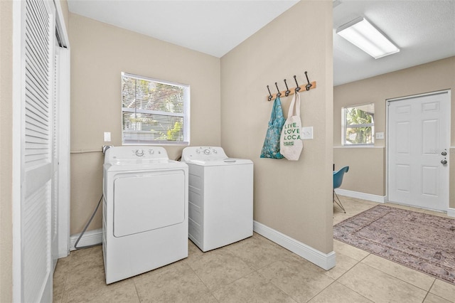 3300 Jackson St N, Saint Petersburg, FL 33704 - laundry area with tile patterned floors, separate washer and dryer, laundry area, and baseboards