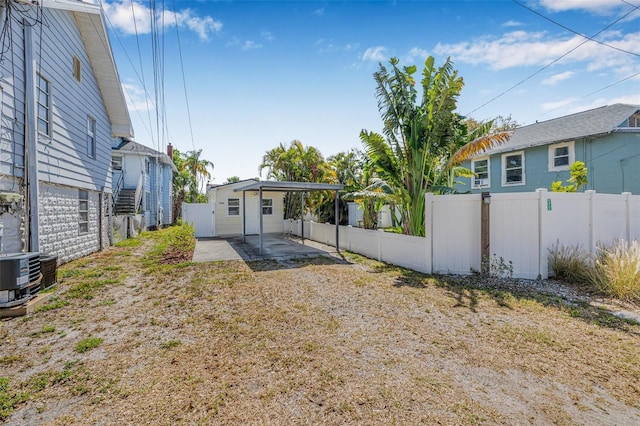 3300 Jackson St N, Saint Petersburg, FL 33704 - back of house featuring a carport, cooling unit, a patio, and fence private yard