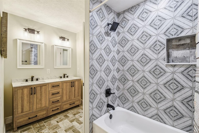 full bathroom featuring a sink, stone finish floor, shower / bathing tub combination, and double vanity