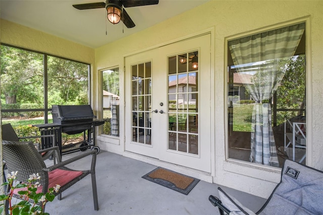 sunroom / solarium with french doors and a ceiling fan
