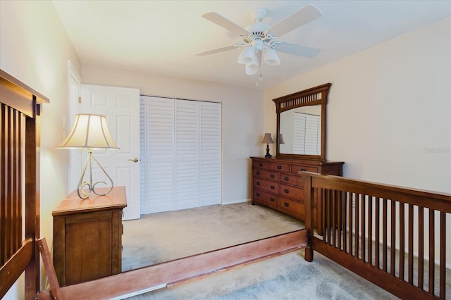carpeted bedroom featuring a ceiling fan and a closet