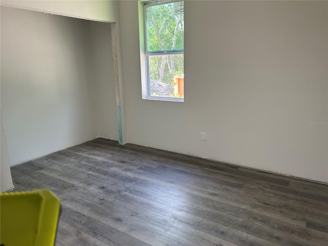 spare room featuring dark wood finished floors