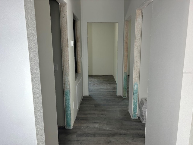 corridor featuring visible vents and wood finished floors