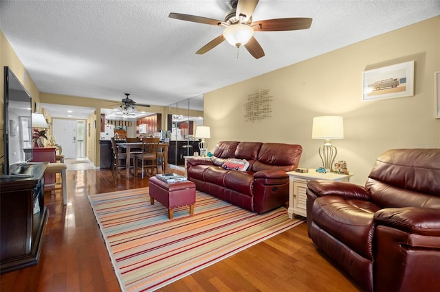 1817 Golfview Dr Unit 1817, Tarpon Springs, FL 34689 - living area featuring a textured ceiling, wood finished floors, and a ceiling fan
