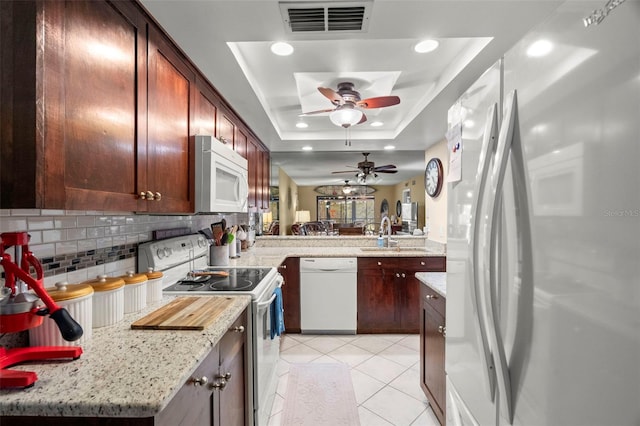 1817 Golfview Dr Unit 1817, Tarpon Springs, FL 34689 - kitchen featuring a sink, a raised ceiling, visible vents, white appliances, and a ceiling fan